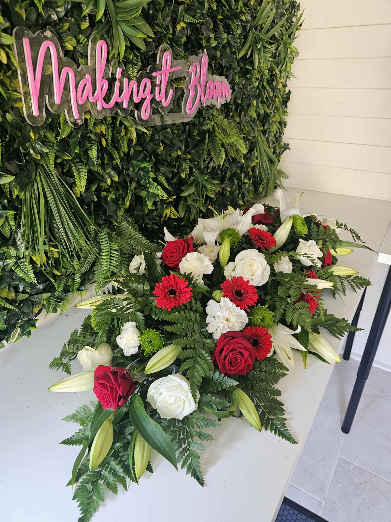 Red and white funeral spray created with care